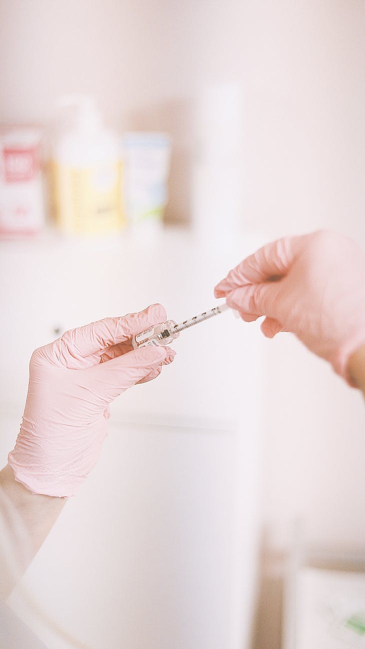 professional hand in aesthetic clinic preparing injection